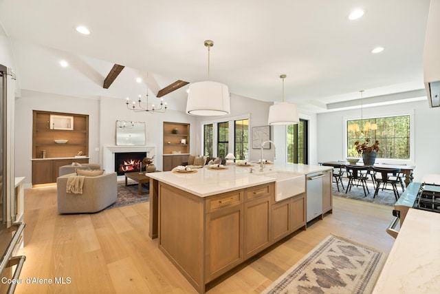 11551 N Bluejay Loop, Hayden, ID 83835 - kitchen featuring dishwasher, a chandelier, light wood-style floors, a warm lit fireplace, and recessed lighting