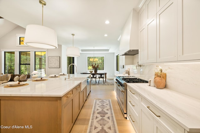11551 N Bluejay Loop, Hayden, ID 83835 - kitchen featuring stainless steel appliances, custom range hood, backsplash, light wood-style flooring, and recessed lighting
