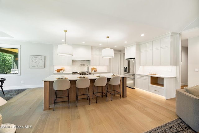 11551 N Bluejay Loop, Hayden, ID 83835 - kitchen featuring high end refrigerator, light wood-type flooring, backsplash, light countertops, and recessed lighting
