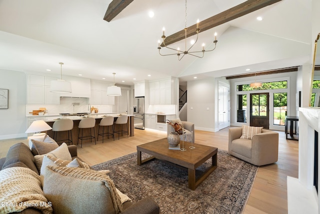 11551 N Bluejay Loop, Hayden, ID 83835 - living area featuring beamed ceiling, light wood finished floors, stairs, high vaulted ceiling, and recessed lighting
