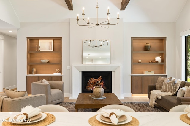 11551 N Bluejay Loop, Hayden, ID 83835 - living room with a chandelier, built in shelves, light wood-type flooring, beam ceiling, and a warm lit fireplace