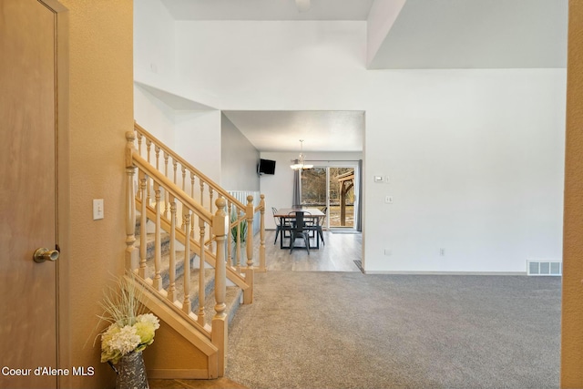 3206 N Lodgepole Rd, Coeur Dalene, ID 83815 - foyer entrance with stairway, a chandelier, and carpet flooring