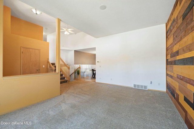 3206 N Lodgepole Rd, Coeur Dalene, ID 83815 - empty room with ceiling fan, carpet flooring, stairway, and a towering ceiling