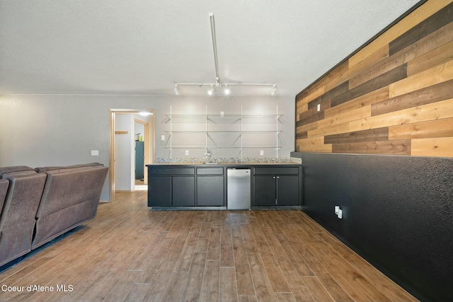 3206 N Lodgepole Rd, Coeur Dalene, ID 83815 - kitchen featuring refrigerator, wood finished floors, wood walls, open floor plan, and light countertops