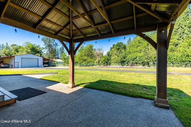 3206 N Lodgepole Rd, Coeur Dalene, ID 83815 - view of patio / terrace with an outbuilding, a gazebo, a detached garage, and view of wooded area