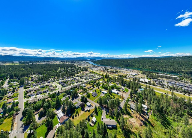 3206 N Lodgepole Rd, Coeur Dalene, ID 83815 - aerial perspective of suburban area featuring a heavily wooded area and a mountain backdrop