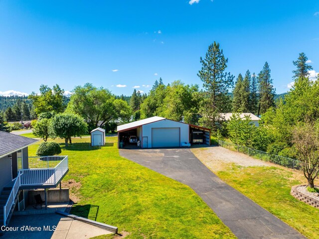 3206 N Lodgepole Rd, Coeur Dalene, ID 83815 - view of front of home with a detached garage, asphalt driveway, and a shed