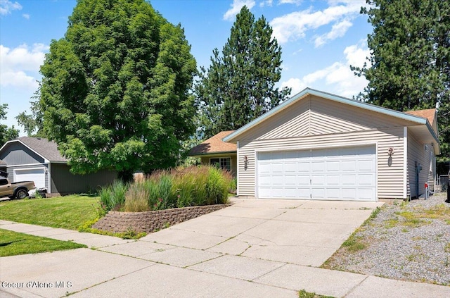 7315 W Lund St, Rathdrum, ID 83858 - ranch-style home with a garage, a front yard, and driveway
