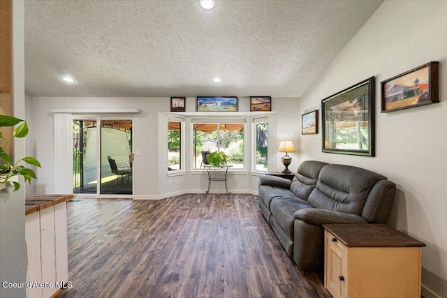 7315 W Lund St, Rathdrum, ID 83858 - living area with a textured ceiling, dark wood-style flooring, plenty of natural light, and recessed lighting