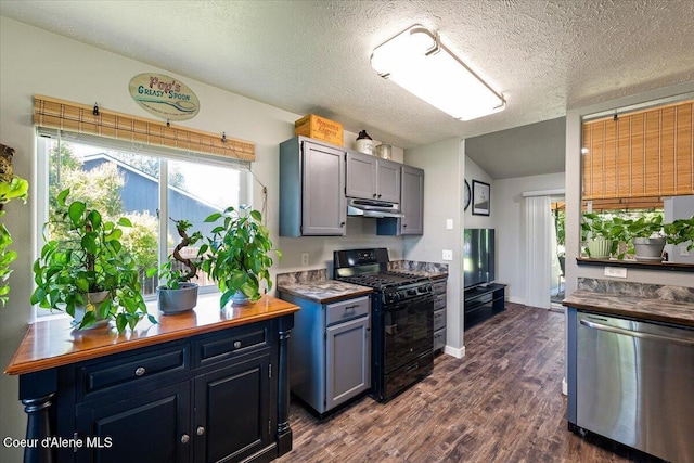 7315 W Lund St, Rathdrum, ID 83858 - kitchen featuring black gas stove, dishwasher, under cabinet range hood, dark wood-style flooring, and lofted ceiling