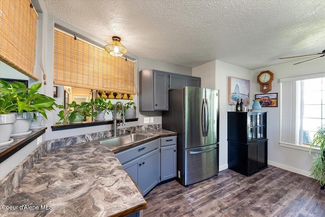 7315 W Lund St, Rathdrum, ID 83858 - kitchen featuring freestanding refrigerator, a textured ceiling, dark wood-style flooring, ceiling fan, and dark countertops