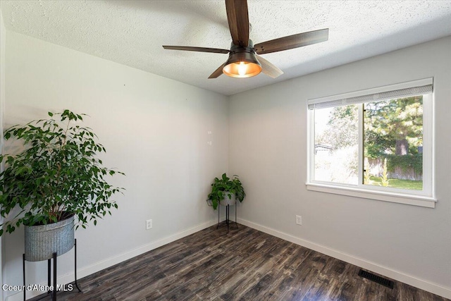 7315 W Lund St, Rathdrum, ID 83858 - spare room with dark wood-style floors, ceiling fan, and a textured ceiling