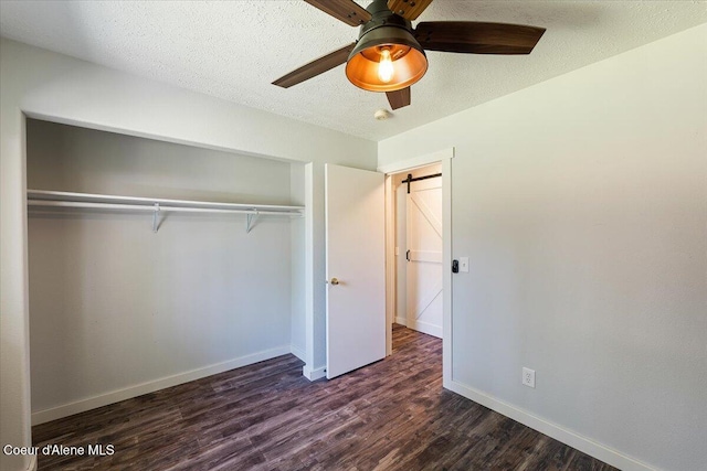 7315 W Lund St, Rathdrum, ID 83858 - unfurnished bedroom featuring dark wood finished floors, a closet, a ceiling fan, and a textured ceiling