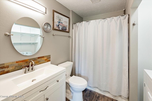 7315 W Lund St, Rathdrum, ID 83858 - full bathroom featuring vanity, wood finished floors, a textured ceiling, and shower / bath combo