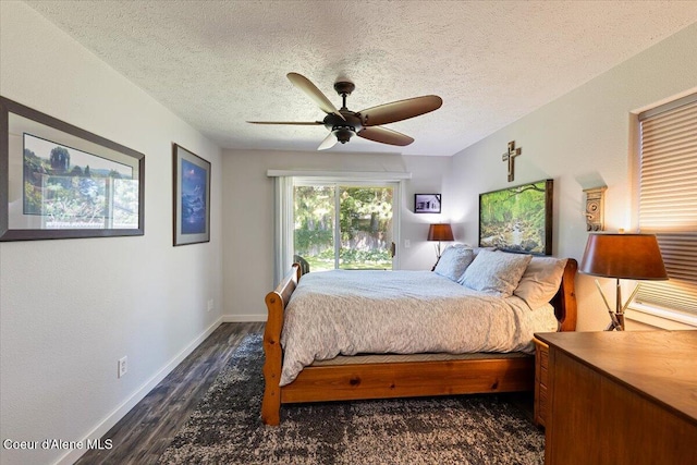 7315 W Lund St, Rathdrum, ID 83858 - bedroom featuring dark wood-style flooring, a textured ceiling, and ceiling fan