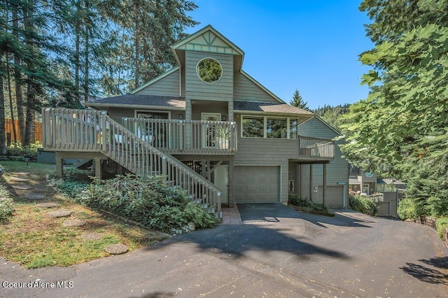 5653 W Racquet Rd, Rathdrum, ID 83858 - view of front facade with driveway, a garage, stairs, and roof with shingles