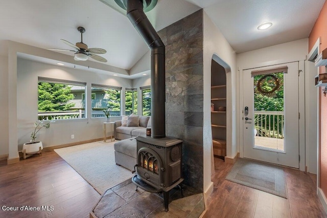 5653 W Racquet Rd, Rathdrum, ID 83858 - foyer entrance with a wood stove, hardwood / wood-style flooring, ceiling fan, lofted ceiling, and plenty of natural light