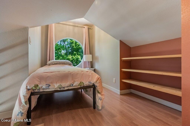5653 W Racquet Rd, Rathdrum, ID 83858 - bedroom featuring lofted ceiling and wood finished floors