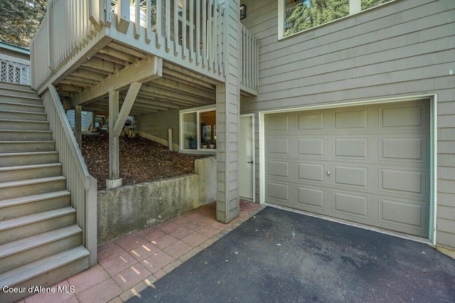 5653 W Racquet Rd, Rathdrum, ID 83858 - view of side of property with stairway, driveway, and a garage