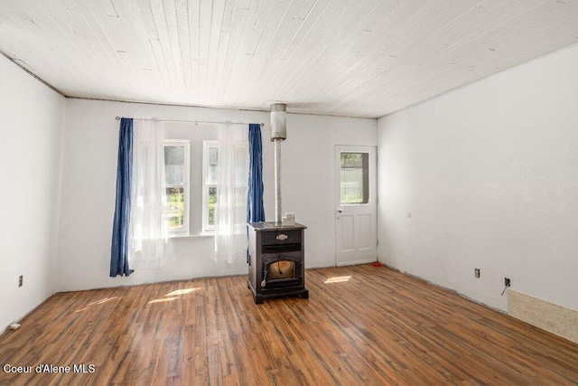 17320 E Perimeter Rd, Athol, ID 83801 - unfurnished living room featuring a wood stove, wood finished floors, and wooden ceiling
