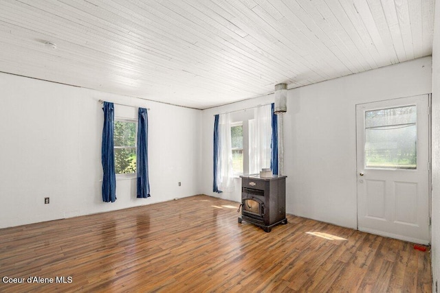 17320 E Perimeter Rd, Athol, ID 83801 - empty room featuring a wood stove, healthy amount of natural light, wood finished floors, and wooden ceiling