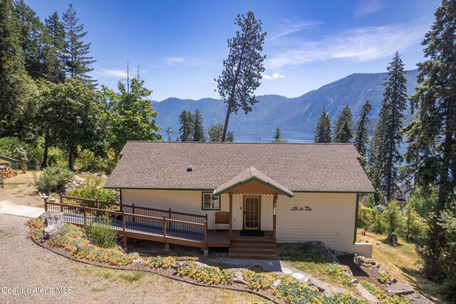 17544 E Arapaho Rd, Bayview, ID 83803 - view of front of house with roof with shingles and a deck with mountain view