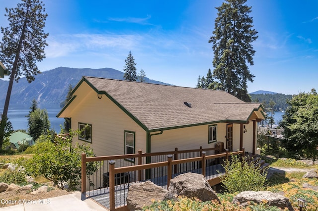 17544 E Arapaho Rd, Bayview, ID 83803 - back of house featuring roof with shingles and a deck with mountain view