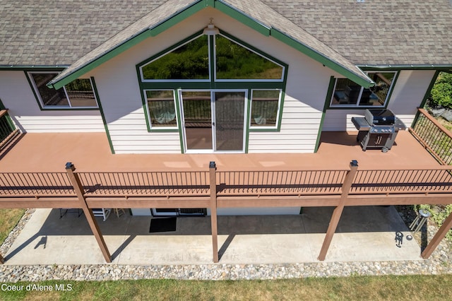 17544 E Arapaho Rd, Bayview, ID 83803 - back of house with a shingled roof and a patio area