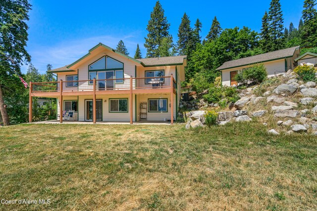 17544 E Arapaho Rd, Bayview, ID 83803 - rear view of property featuring a patio, a lawn, and a wooden deck
