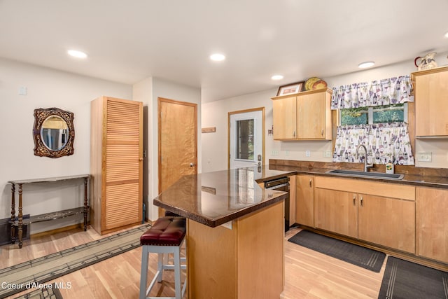 17544 E Arapaho Rd, Bayview, ID 83803 - kitchen with dark countertops, light wood finished floors, a breakfast bar, dishwasher, and recessed lighting