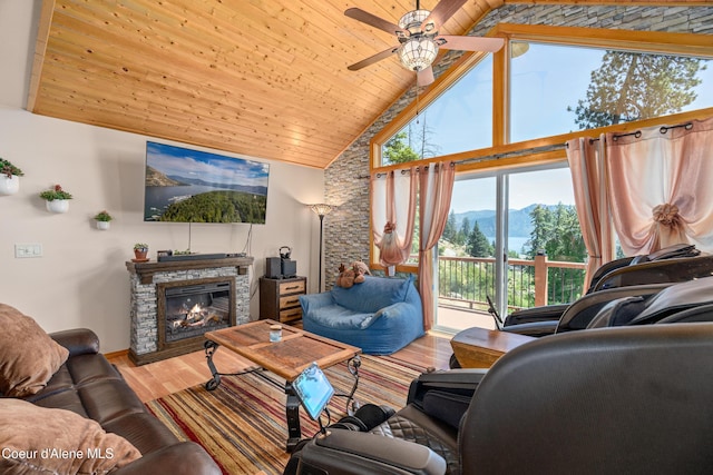 17544 E Arapaho Rd, Bayview, ID 83803 - living room featuring wood finished floors, high vaulted ceiling, a ceiling fan, wooden ceiling, and a fireplace