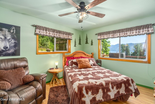 17544 E Arapaho Rd, Bayview, ID 83803 - bedroom with wood finished floors and ceiling fan