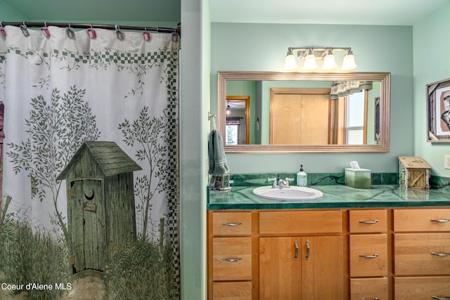 17544 E Arapaho Rd, Bayview, ID 83803 - full bath with vanity, healthy amount of natural light, and a shower with curtain