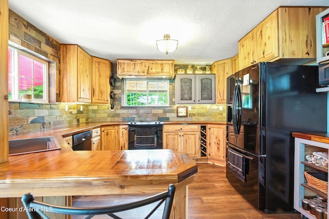 80 Half Cir, Priest River, ID 83856 - kitchen featuring black appliances, decorative backsplash, dark wood-type flooring, light countertops, and a peninsula