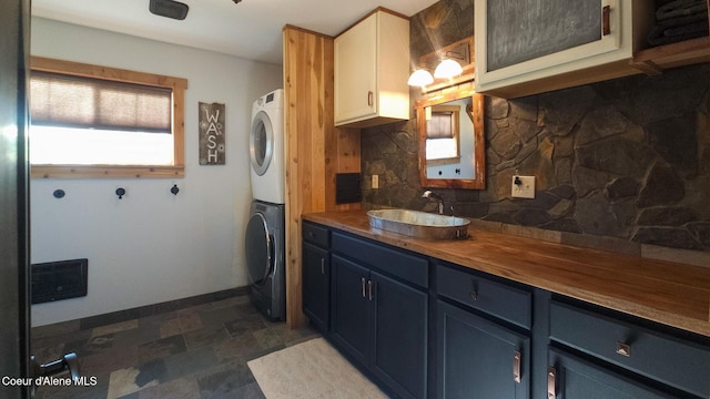 80 Half Cir, Priest River, ID 83856 - laundry area with stacked washer and clothes dryer and dark stone finish flooring