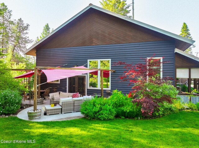 80 Half Cir, Priest River, ID 83856 - rear view of property featuring outdoor lounge area, a lawn, and a patio