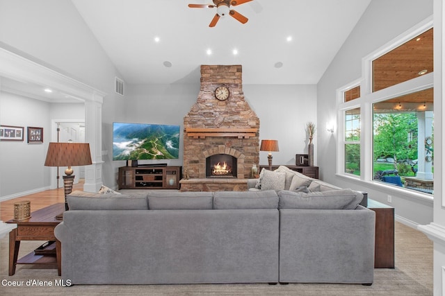 12155 N Yearling Cir, Hayden, ID 83835 - living area with ceiling fan, a stone fireplace, high vaulted ceiling, and recessed lighting