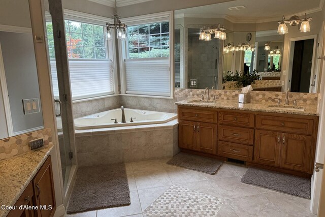 12155 N Yearling Cir, Hayden, ID 83835 - bathroom featuring a chandelier, double vanity, ornamental molding, a bath, and a shower stall