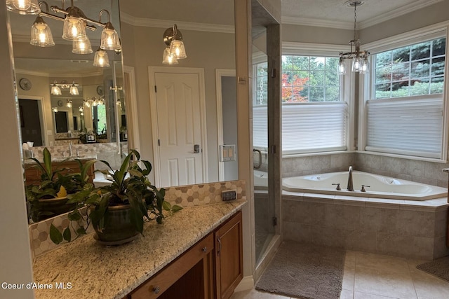 12155 N Yearling Cir, Hayden, ID 83835 - bathroom featuring tile patterned flooring, a bath, vanity, a chandelier, and a stall shower