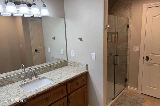 12155 N Yearling Cir, Hayden, ID 83835 - bathroom featuring a shower stall, vanity, and tile patterned floors
