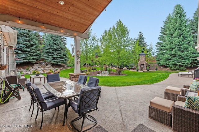 12155 N Yearling Cir, Hayden, ID 83835 - view of patio / terrace featuring exterior fireplace and outdoor dining area