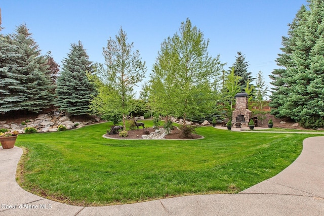 12155 N Yearling Cir, Hayden, ID 83835 - view of green lawn featuring an outdoor fireplace