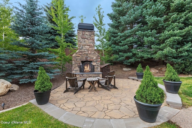 12155 N Yearling Cir, Hayden, ID 83835 - view of patio with an outdoor stone fireplace