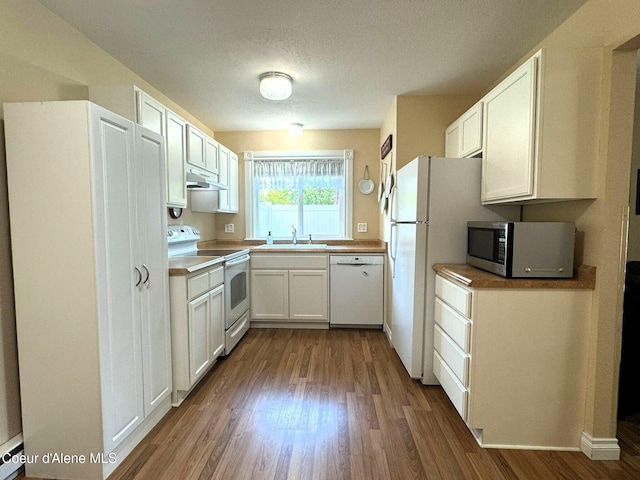 623 E Whispering Pines Ln # 3, Coeur Dalene, ID 83815 - kitchen with white appliances, dark wood finished floors, under cabinet range hood, white cabinetry, and a textured ceiling