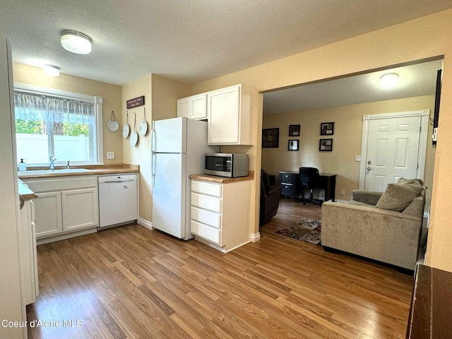 623 E Whispering Pines Ln # 3, Coeur Dalene, ID 83815 - kitchen featuring white appliances, light wood-style flooring, an office area, and white cabinets