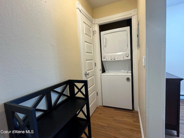 623 E Whispering Pines Ln # 3, Coeur Dalene, ID 83815 - laundry room with stacked washer and clothes dryer, a textured wall, and wood finished floors