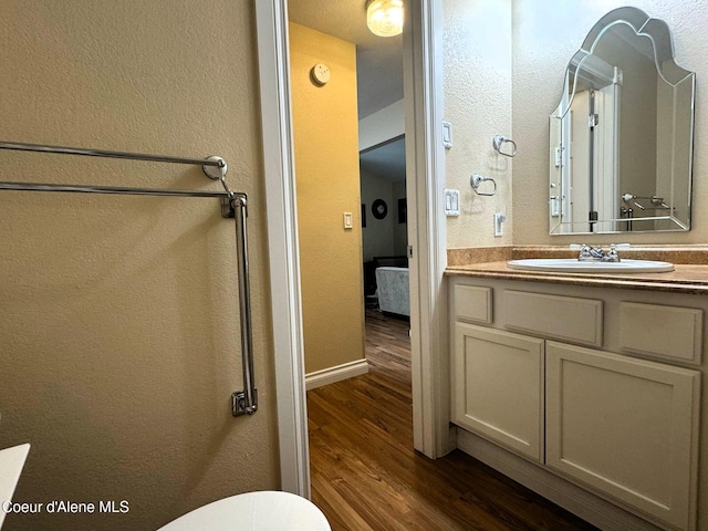 623 E Whispering Pines Ln # 3, Coeur Dalene, ID 83815 - bathroom with wood finished floors and vanity