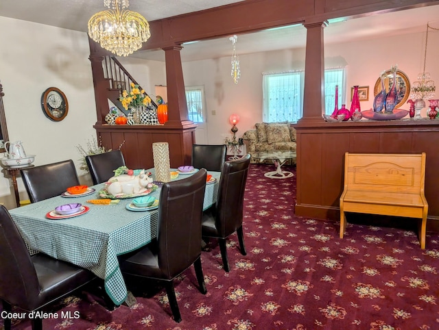 6702 Kelso Lake Rd, Athol, ID 83801 - carpeted dining area with decorative columns, stairs, and a chandelier