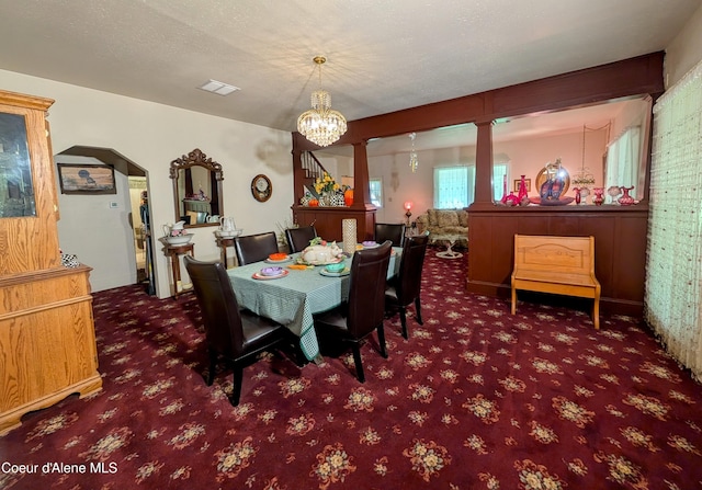 6702 Kelso Lake Rd, Athol, ID 83801 - dining space with carpet floors, a chandelier, and arched walkways