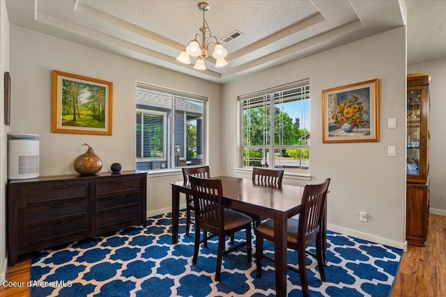 1232 W Grove Way, Coeur Dalene, ID 83815 - dining room with a chandelier, wood finished floors, and a tray ceiling